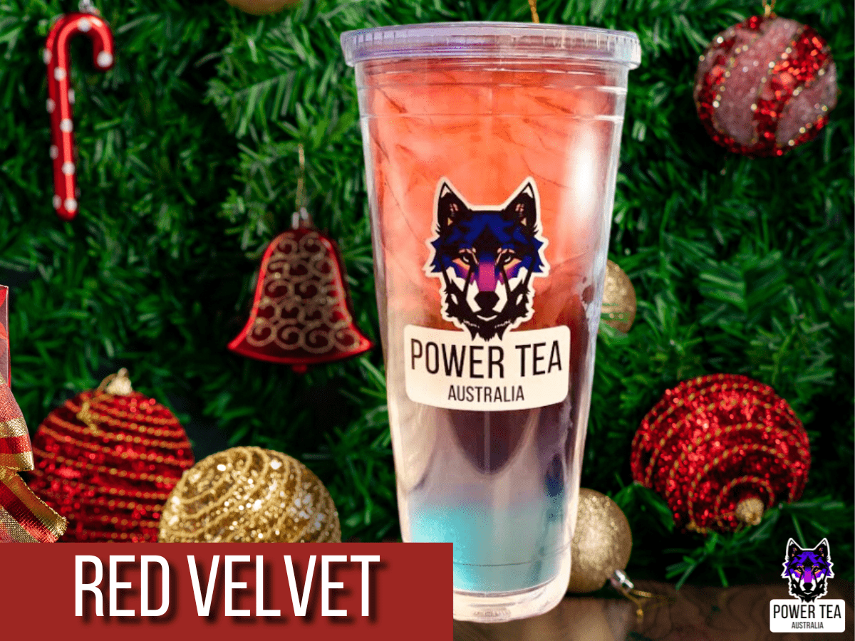 a cup with Power Tea's Red velvet drink blend, in a christmas setting